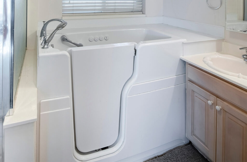 Walk-in tub with low-entry door and built-in seating for accessible bathing.