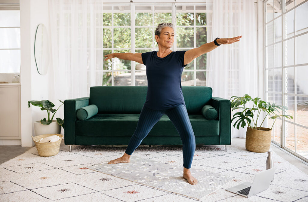Older adult exercising comfortably in an accessible living room.