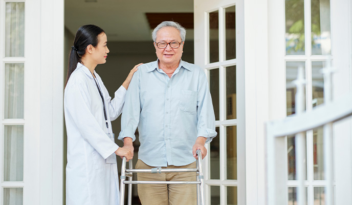 Older adult using a safe, accessible home entrance with secure handrails.
